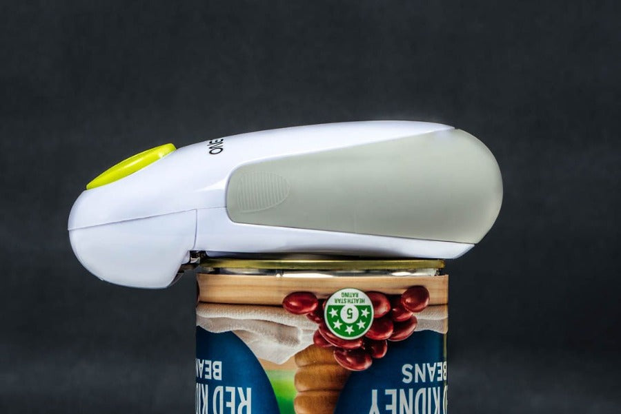 automatic can opener by one touch. white with green button. battery operated makes opening cans simple just use one finger